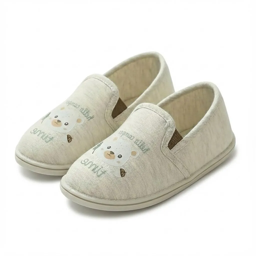 Color beige side view of toddler cartoon jersey slippers