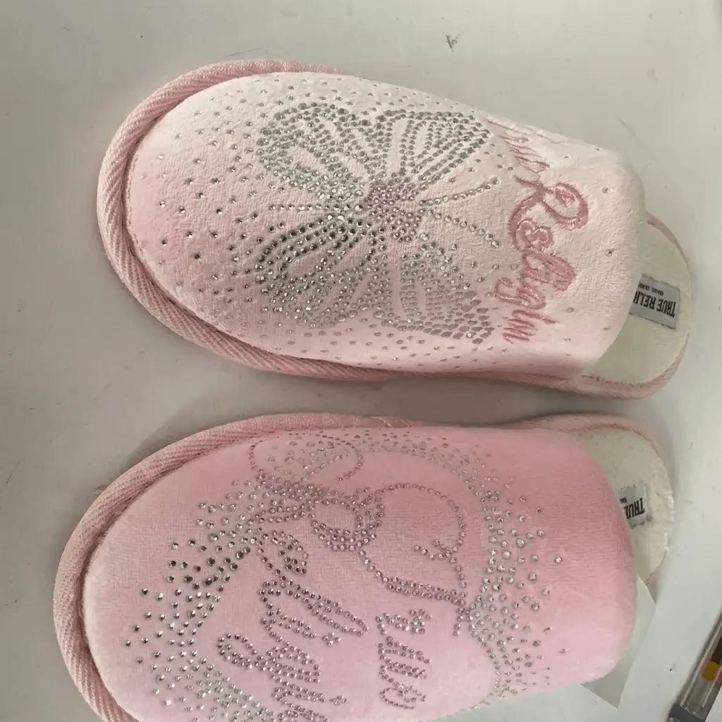 Custom pink plush indoor slippers featuring intricate hot-fix rhinestone designs and precision embroidery