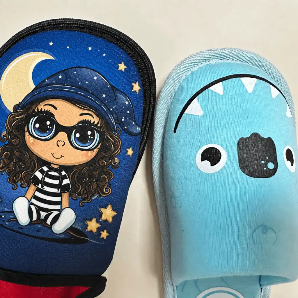 Custom printed slippers showing detailed multicolor and simple graphic designs on textile uppers