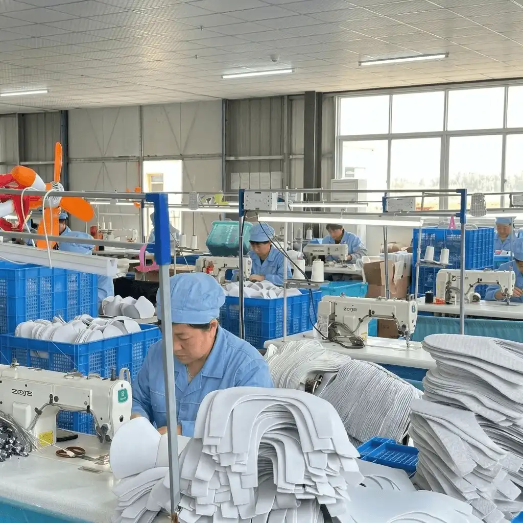 View of a synchronized, high-volume sewing assembly line in a professional slipper factory, showcasing massive manufacturing capacity for OEM orders,ensuring a fast custom indoor slipper OEM lead time.