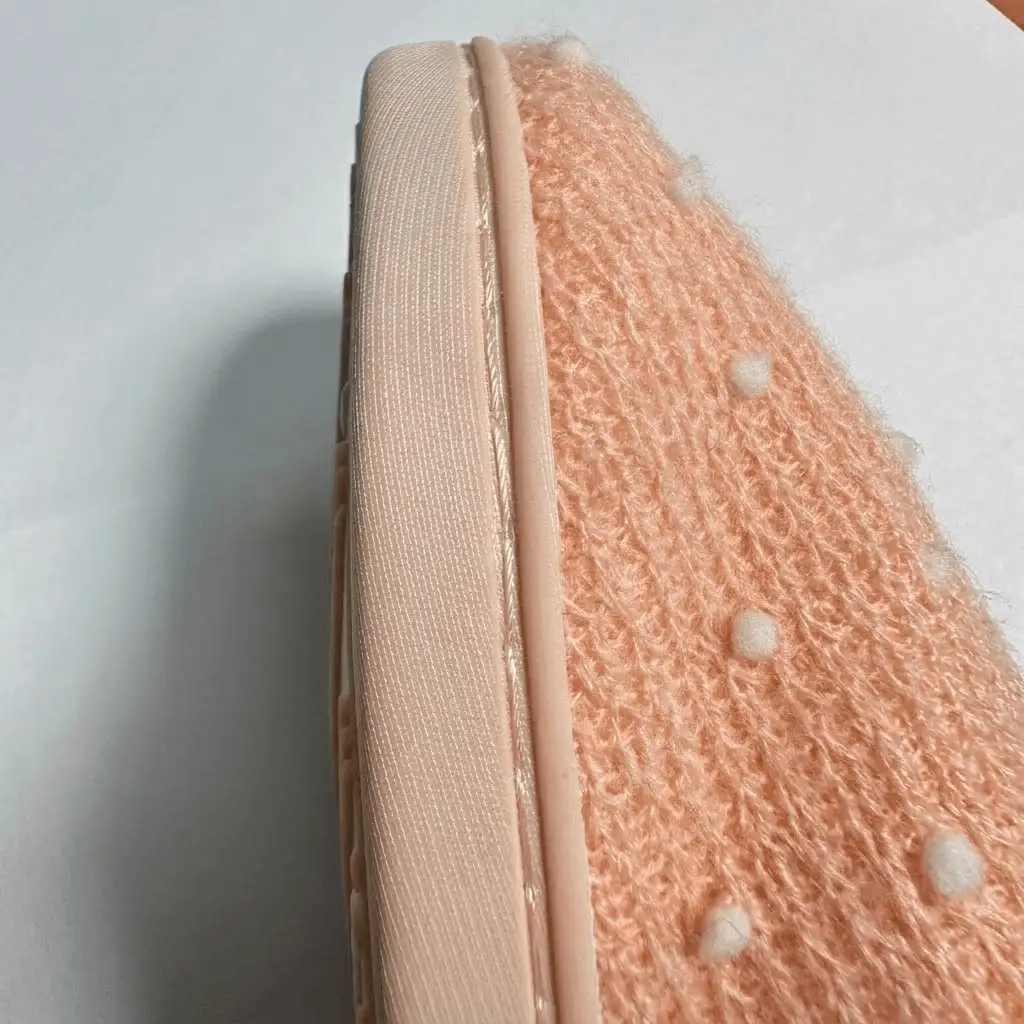 Close-up of durable side seam stitching, a key factor in custom indoor slipper manufacturing cost
